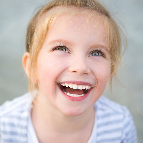 A child smiling with healthy teeth