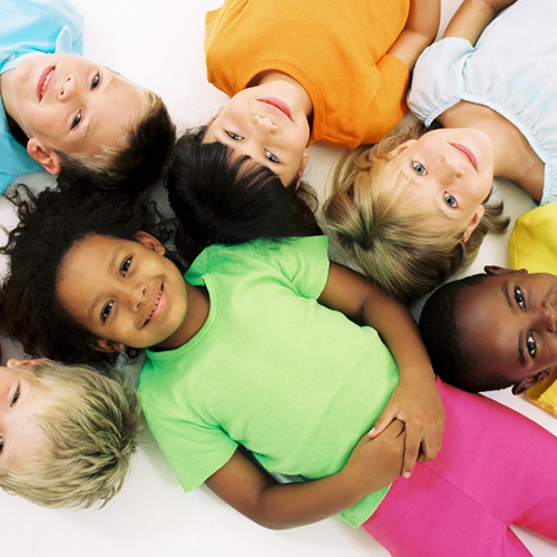 happy children with healthy smiles raising their hands at Dino Kids Pediatric Dentists