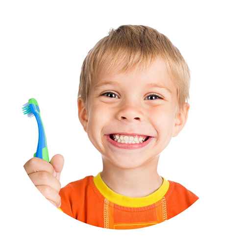 A child holding a toothbrush and smiling