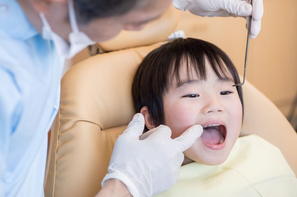Dentist checking a child for toddler cavities