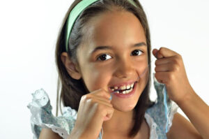 Flossing teeth - one of the most important pediatric dentistry tips for athletes.