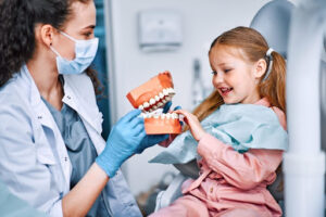 Alt Tag: Dentist educating a child about the importance of early dental visits.